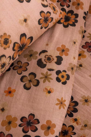 Detail shot of the Woodstock Floral Cotton Muslin Bedding Set, showing the retro floral pattern. 