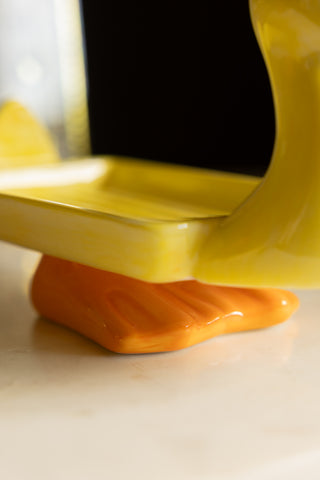 Close-up of the feet of the Yellow Duck Soap Dish.
