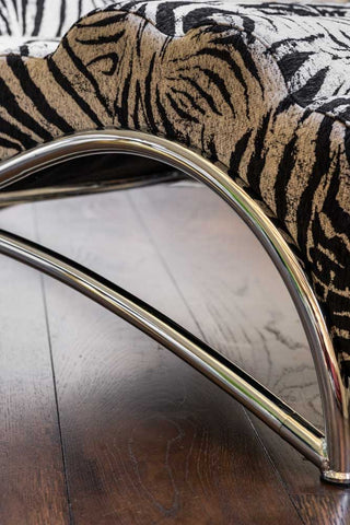 The arched metal base of the Zebra Print Lounger Chair. 