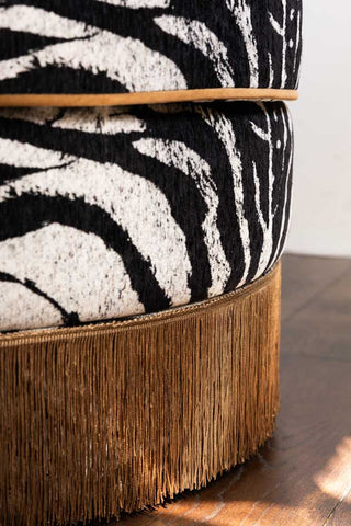 Detail of the gold fringe and piping on the Zebra Print Tassel Swivel Chair.