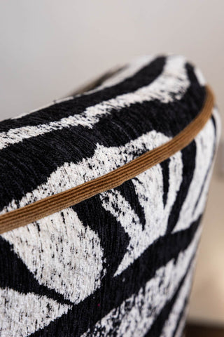 Close up detail of the gold piping on the back of the Zebra Print Tassel Swivel Chair.