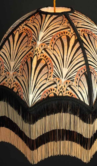 Close up of Anna Hayman ceiling lampshade in a fan deco pattern with a black and white wave fringe.