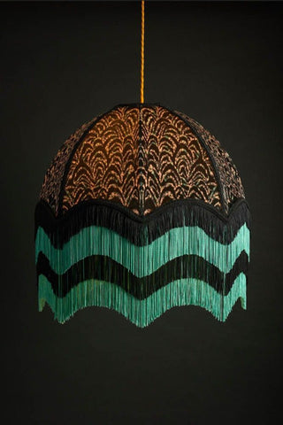 An art deco inspired lampshade in black with a teal and black fringing on the bottom. 