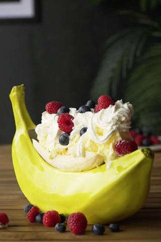 Image of the banana boat filled with bananas, cream and berries