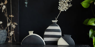 image of three vases against a dark background 
