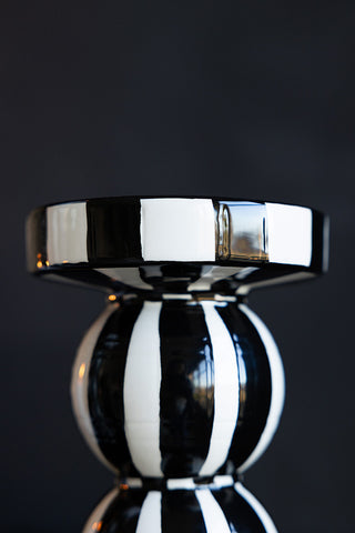 Close-up of the side of a black and white striped candle holder.