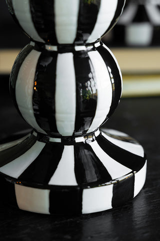 Close-up of the base of a black and white striped candle holder.