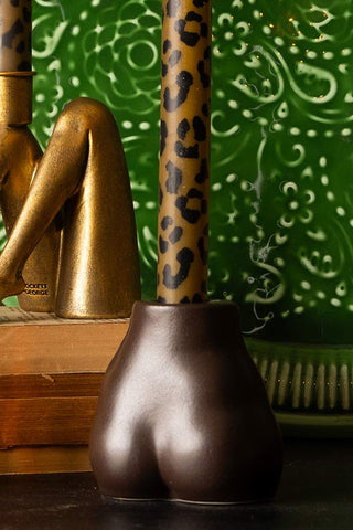 Brown bottom candlestick holder with leopard print candle.