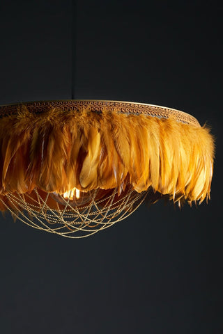 Close-up image of the Juliette Fabulous Feather Chandelier Featuring Chains in Mustard Yellow