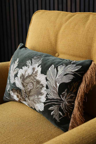 Angled image of the Floral Embroidered Cushion With Golden Fringe