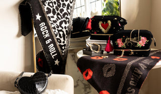 Various gifts styled on a table & sofa, with a mirror in the background.