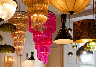 Beautiful image of pink, rose pink, black cone, green palm and leopard print ceiling lights suspended from the ceiling.