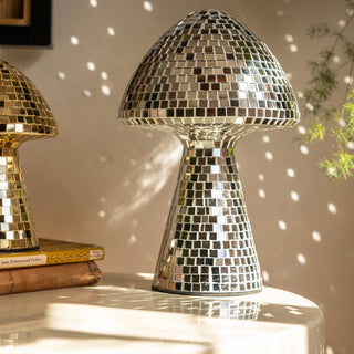 The Large Disco Mushroom Ornament displayed on a white table, reflecting light around the room in the sunshine.