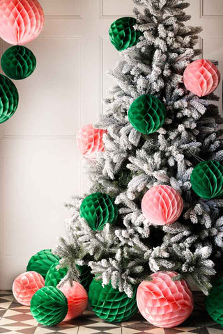 pink and green paper balls on a frosted tree.