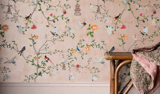 Pretty floral wallpaper featuring birds, birdcages and flowers hanging from lush floral branches. 