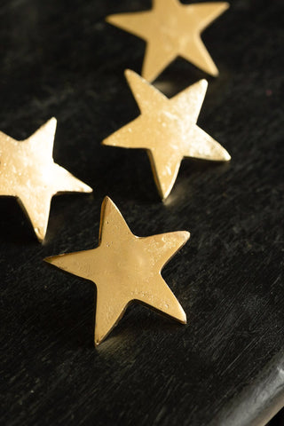 Close-up image of the Set Of 4 Gold Star Pillar Candle Pins