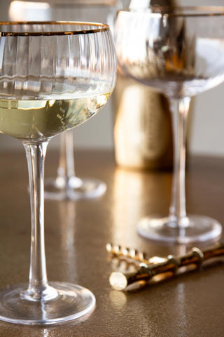 Close-up image of the Set Of 4 Ribbed Champagne Coupe Glasses With Gold Rim
