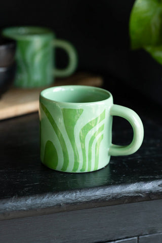 Lifestyle image of the Small Green Abstract Marble Mug