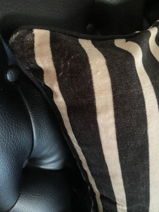 Close up of the corner of the Monochrome Striped Velvet Cushion Cover.
