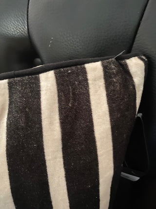 Detail of the corner on the Monochrome Striped Velvet Cushion Cover.