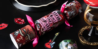 A red christmas cracker that says 'never mind the baubles it's Christmas' printed on it.