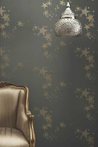 lifestyle image of Barneby Gates All Star Wallpaper - Gun Metal with gold armchair and silver ceiling light