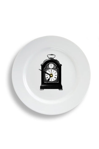 A striking ceramic plate wall clock with an old fashioned carriage  clock on the front. 