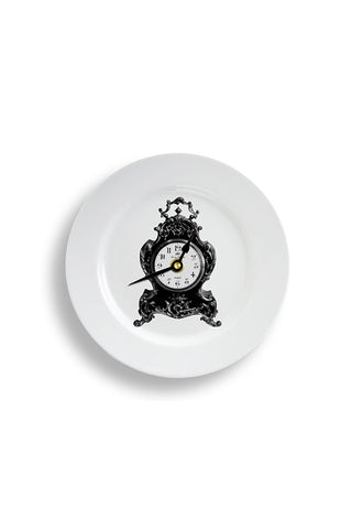 A pretty ceramic plate wall clock with an old fashioned clock on the front. 