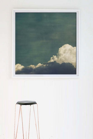 lifestyle image of cloud play II by jr goodwin - etching paper or canvas with black and gold stool and white wall background
