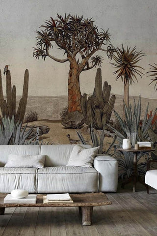 Lifestyle image of the Desert Landscape Wallpaper Mural - Meiji Maca with plae grey sofa with wooden coffee table in front and wooden side table with white vases on top at the side on wooden flooring
