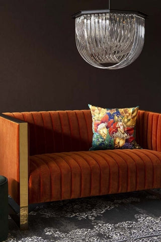 Lifestyle image of the Retro 50's Style Burnt Orange Velvet 2 Seater Sofa With Gold Trim with Opulent Crystal Pendant Ceiling Light and Exotic Jungle Velvet Cushion