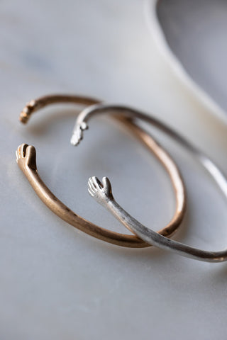 Image of the Adjustable Silver Hugs Bangle with the gold bangle