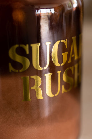Close-up image of the Amber Glass Storage Jar With Black Lid - Sugar Rush