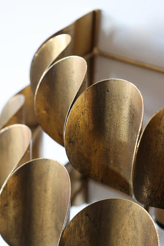 Close-up image of the Antique Brass Curve Disc Wall Light