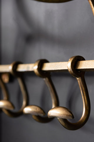 Close-up image of the Antique Gold Luggage Rack With Coat Hooks