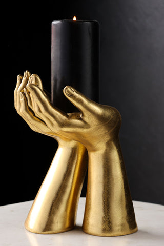 Lifestyle image of the Antique Gold Palm Hand Candle Holder