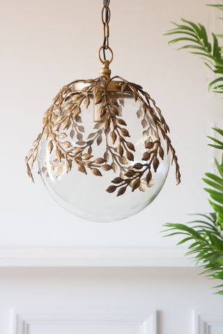 Lifestyle image of the Ornate Globe Pendant Ceiling Light With Brass Leaf Detailing