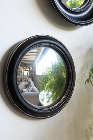 Lifestyle image of the Antique Black Round Framed Medium Convex Mirror
