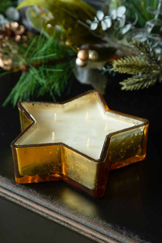 Lifestyle image of the Balsam Cedar Gold Star Candle