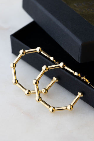 Lifestyle image of the Bar & Ball Gold Hoop Earrings
