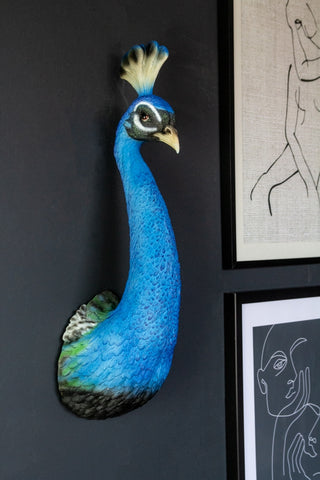 Side angle lifestyle image of the Beautiful Blue Peacock Head Wall Decoration