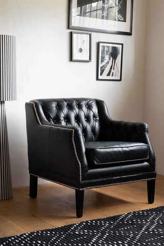 Lifestyle image of the Black Buttoned Back Leather Armchair