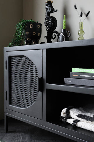 Close-up lifestyle image of the Black Cane TV Stand / Entertainment Unit