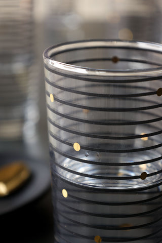 Close-up image of the pattern on the Black Rings With Gold Spots Hi-Ball Glass