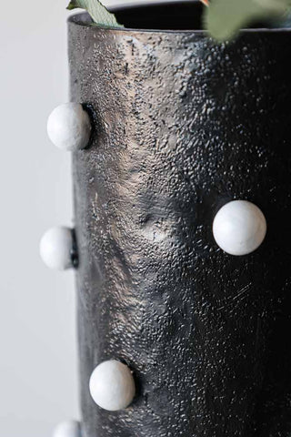 Close-up image of the Black Vase With White Spots