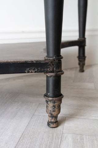 Close-up image of the legs & feet on the Black Vintage Style Metal Distressed Console Table With Drawer
