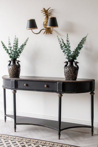 Angled lifestyle image of the Black Vintage Style Metal Distressed Console Table With Drawer