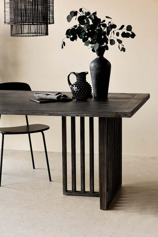 Lifestyle image of the Black Wood Dining Table With Slatted Legs