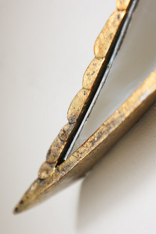 Close-up image of the tail tip on the Brass & Mirror Swallow Wall Decoration