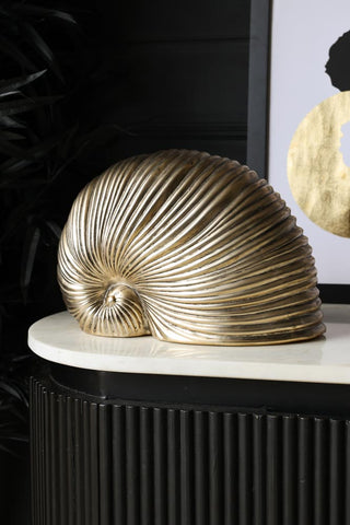 Lifestyle image of the Brushed Gold Faux Sea Shell Ornament